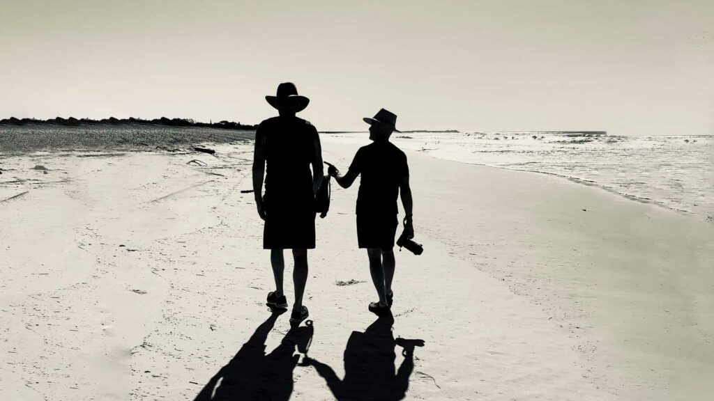 Image of two men walking on beach